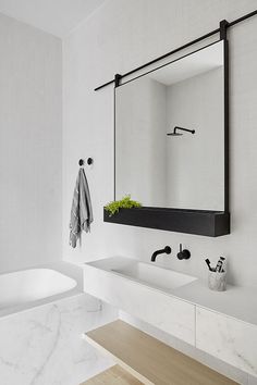 an iphone photo of a bathroom with black and white decor on the wall, along with other items