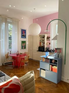 a living room filled with furniture next to a window covered in curtains and light colored walls