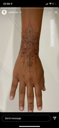 a person's hand with a tattoo on it