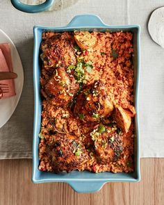 a blue dish filled with meat and rice