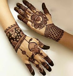 two hands with henna designs on them