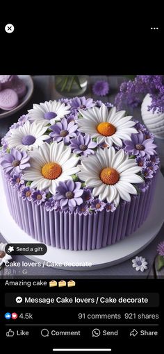 the cake is decorated with daisies and purple flowers