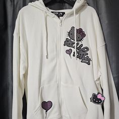 Nwt F21 X Hello Kitty Rhinestone Zip-Up Hoodie With Rubber Hello Kitty Decoration Size Medium Details From Our Hello Kitty And Friend's X Forever21 Collection, This Fleece Zip-Up Hoodie Features Front And Back " Hello Kitty " Text And Character Graphics Rhinestones Embellishments A Drawstring Hood Long Sleeves Split Kangaroo Pocket And Ribbed Trim 2023 Sanrio Co.Ltd Sold Out Online From Smoke Free Home Y2k White Cotton Outerwear, White Cotton Y2k Outerwear, White Y2k Streetwear Outerwear, White Y2k Outerwear For Streetwear, White Y2k Style Streetwear Outerwear, White Y2k Hoodie For Spring, Hello Kitty Text, Hello Kitty Rhinestone, Hello Kitty Decorations