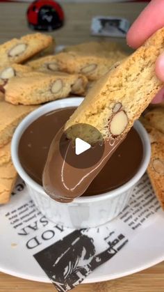 someone is dipping some chocolate into their cookies