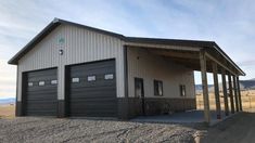 a two car garage sitting on top of a dirt field