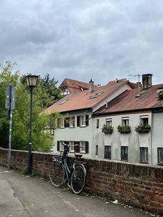 two bikes parked next to each other in front of a brick wall and street light