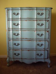 an old dresser is painted blue and white