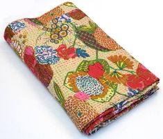 a cloth covered in colorful flowers on a white surface