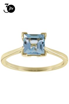 a yellow gold ring with an aqua blue topazte stone