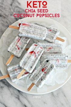 three ice cream popsicles on a white plate with red and black sprinkles