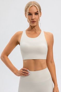 Stay cool and comfortable while working out in our Round Neck Cutout Cropped Active Tank. The round neck and cutout design provide breathability and flexibility, making it perfect for any active lifestyle. Its cropped length adds a stylish and modern touch to your workout attire. Features: Basic style Sheer: Opaque Stretch: Highly stretchy Material composition: 75% nylon, 25% elastane Care instructions: Machine wash cold. Tumble dry low. Imported Product measurements:S:Top Length 12.20 in, Bust Workout Attire, Cutout Design, Crop Top Bra, Maxi Dress Cocktail, Swimwear Cover Ups, Short Leggings, Swimwear Cover, Skirted Swimwear, Basic Style