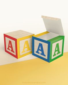 Large DIY building block with the letter A in red, yellow, blue, and green.The paper cube is on a wooden table. Abc Party, Paper Cube, Abc Blocks, Birthday Party At Home, How To Make Banners, Alphabet Blocks, Letter Z, Alphabet Printables, Encouragement Gifts