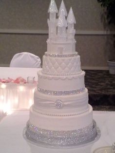 a white wedding cake sitting on top of a table