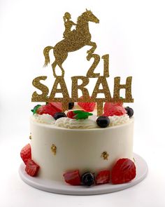 a white cake topped with a horse and the number twenty two on top of it