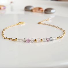 "Minimalist, wearable, and delicate 14k gold-filled bracelet with fluorite, moonstone, and rose quartz gemstones for everyday wearing. Length: from 5,5\" to 8\" with 1\" 14k gold-filled extensor chain. Width: 2mm 14k gold-filled beads and 2-4 mm faceted gemstone beads. Material: 14k gold-filled strong lobster clasp. Handmade in Spain. ✩ Please kindly note that these stones are natural so they can vary slightly in color from the one on the pics. They can also contain some inclusions. ✩ Ideal for Minimalist Gemstone Bracelet, Pregnancy Support, Quartz Gemstones, Miyuki Bracelet, Crystal Beads Bracelet, Bridesmaid Bracelet, Rose Quartz Gemstone, Beaded Bracelets Diy, Healing Jewelry