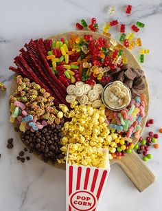 a tray filled with popcorn, candy and candies