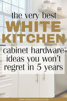 White painted kitchen cabinets with gold hardware, wood flooring, a buffalo plaid rub, black farmhouse pendent light over the sink, white subway backsplash, light wood open shelves on the back wall. The text reads "the very best white kitchen cabinets hardware ideas you won't regret in 5 years" Kitchen Cabinet Door Pulls, White Kitchen Cabinet Handle Ideas, White Cabinet Pulls Hardware, White Cabinets Black Pulls, White Kitchen Cabinets With Oil Rubbed Bronze Hardware, White Dove Kitchen Cabinets Black Hardware, Door Pulls On White Cabinets, Matte Gold Kitchen Hardware, Cabinet Handles For White Cabinets