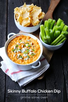 two bowls filled with dip next to green beans and crackers on a wooden table