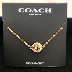 Coach Ny Slider Bracelet Goldtone Gold Logo On Center Circle With Crystal Elegant Rhodium Plated Coach Bracelets As Gift, Coach Adjustable Bracelet As Gift, Adjustable Coach Bracelets As Gift, Adjustable Coach Bracelets For Gift, Formal Adjustable Coach Bracelets, Adjustable Silver Coach Bracelet, Coach Jewelry Bracelet Gift, Coach Bracelet Jewelry Gift, Coach Adjustable Jewelry For Party