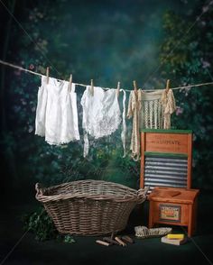 laundry hanging on clothes line next to an old radio and basket with cloths in it