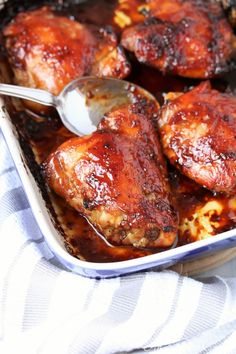 a pan filled with chicken and sauce on top of a table