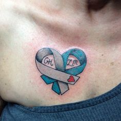 a woman's chest with a blue and gray ribbon in the shape of a heart