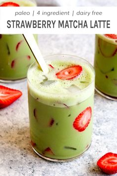 two glasses filled with green smoothie and strawberries