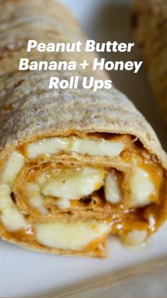 a close up of a burrito on a plate with the words peanut butter, banana and honey roll ups