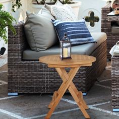 a table sitting on top of a wooden bench next to a couch and chair with pillows