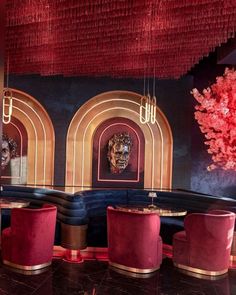 the interior of a fancy restaurant with red and gold decor