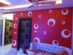 a living room with red and white wallpaper, ceiling fan and sliding glass doors