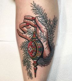 a tattoo on the leg of a person holding a clock