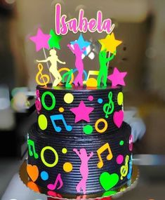 there is a colorful cake with music notes and stars on the top that says barbiela