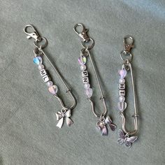 three key chains with charms attached to them