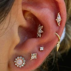 a close up of a person's ear with three different types of piercings