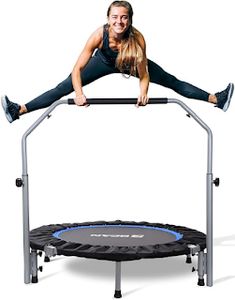 a woman is jumping on a trampoline with her legs spread out and smiling