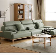 a living room with a couch, coffee table and bookshelf on the wall