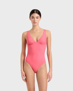 The Nimah One Piece in Rose is a supremely flattering plunge V neck swimsuit featuring adjustable straps, an underwire for support with gathered detail to enhance the bust. Nimah offers regular bottom coverage and a medium to high cut leg. Made using our technically advanced Sculpteur® fabric that flatters and supports the bust, Nimah is suitable for large bust sizes up to DD. Luxury fabric sustainably made in Italy. Luxury Swimsuits, Luxury Fabric, Designer Swimwear, Large Bust, High Cut, Rose Pink, Luxury Fabrics, One Piece Swimsuit, Adjustable Straps