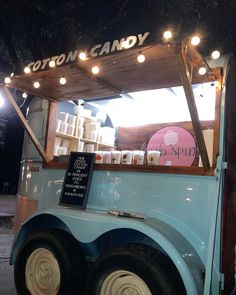 an ice cream truck is parked on the side of the road at night with its lights on