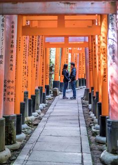 two people standing in front of an orange structure