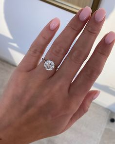 a woman's hand with a diamond ring on it