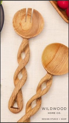 two wooden spoons with twisted handles on a table