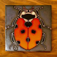 a glass tile with a lady bug on it