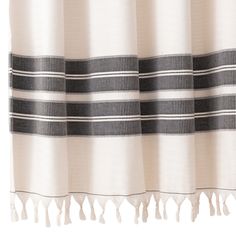 a black and white striped towel hanging on a wall