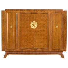 a wooden cabinet with gold decorations on the front and side panels, inlaid to it's sides