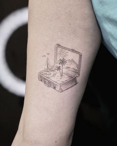 a small laptop computer tattoo on the arm