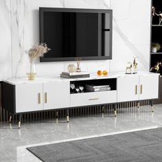 a white and black entertainment center in a living room with marble walls, flooring and rugs