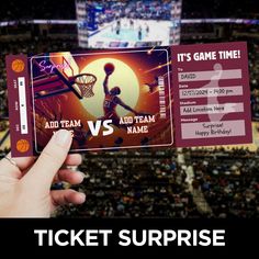 a person holding up a ticket for a game at a basketball game with the words, it's game time and an ad team name