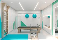 a ping pong table in a room with blue and green balls