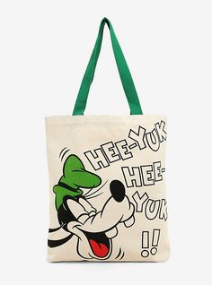 a tote bag with an image of mickey mouse on the front and green handles